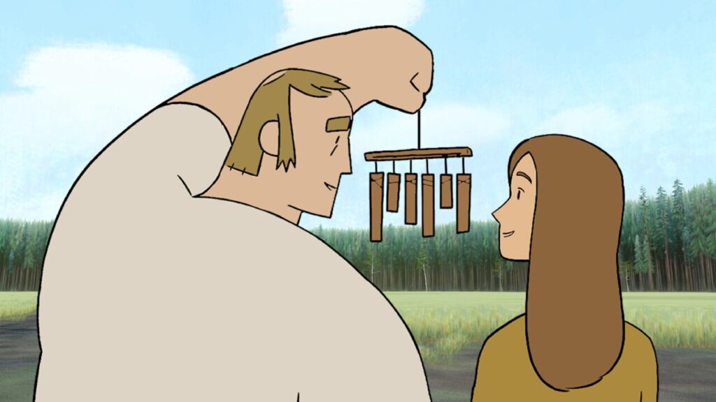 A man shows a woman a wind chime in a field